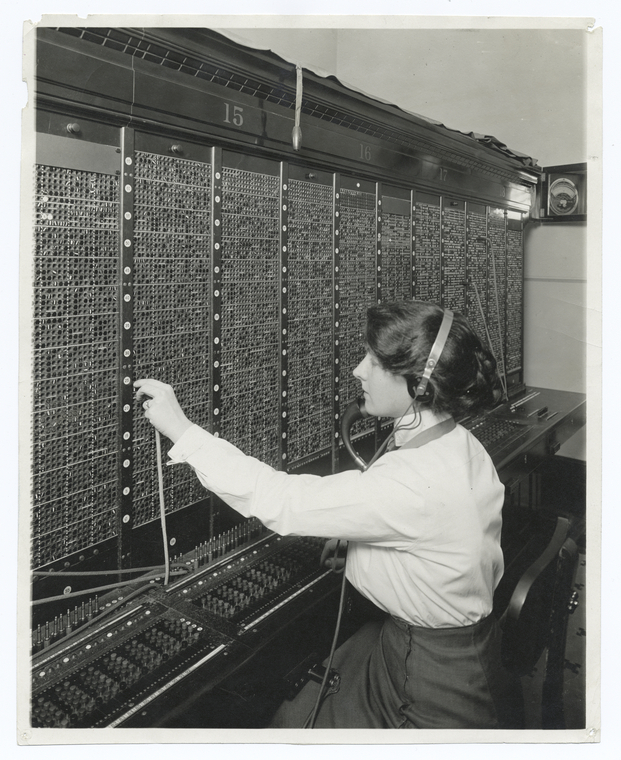 Woman operating an old phone switchboard